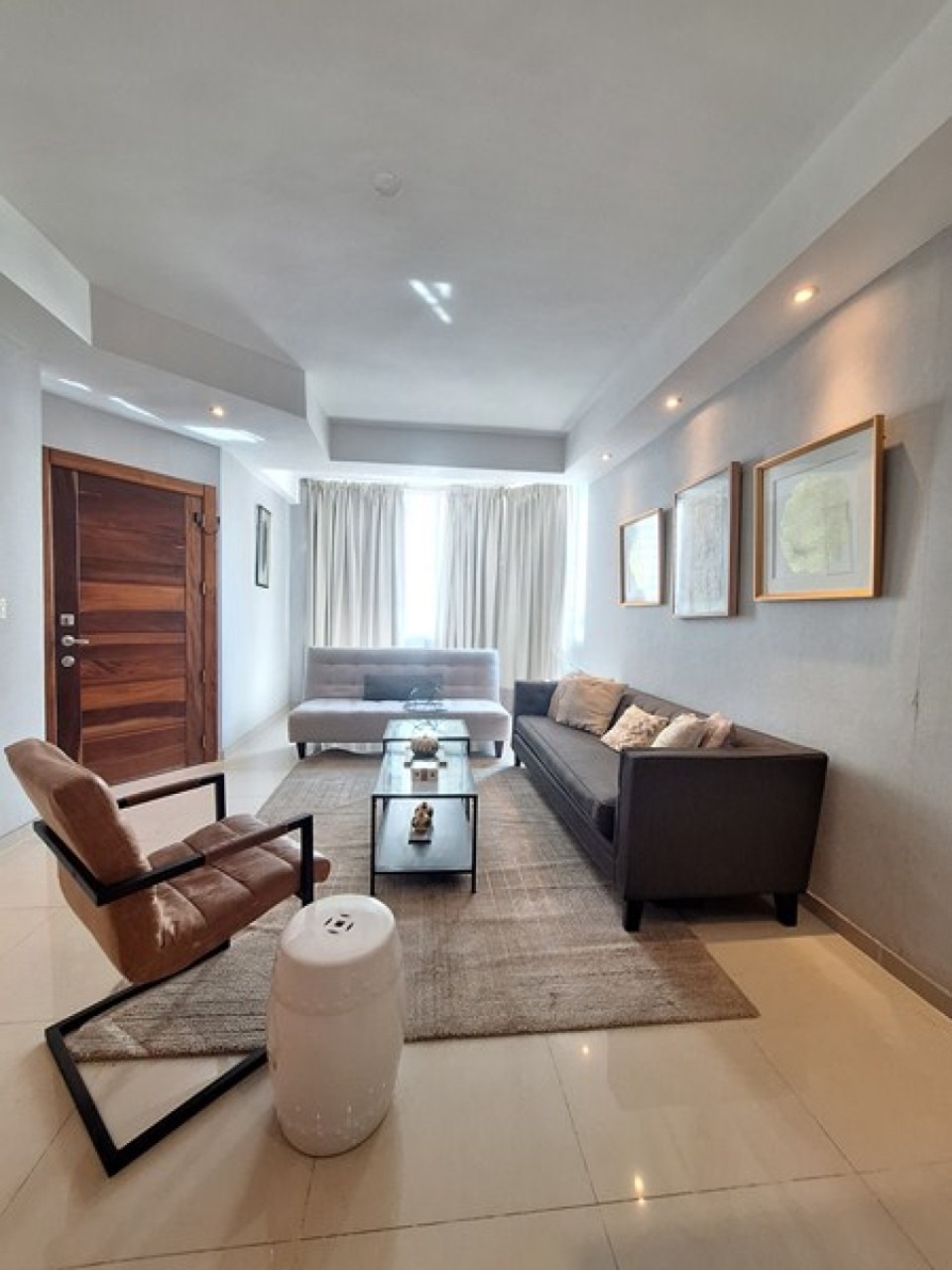 Living room entry with sofa and armchair