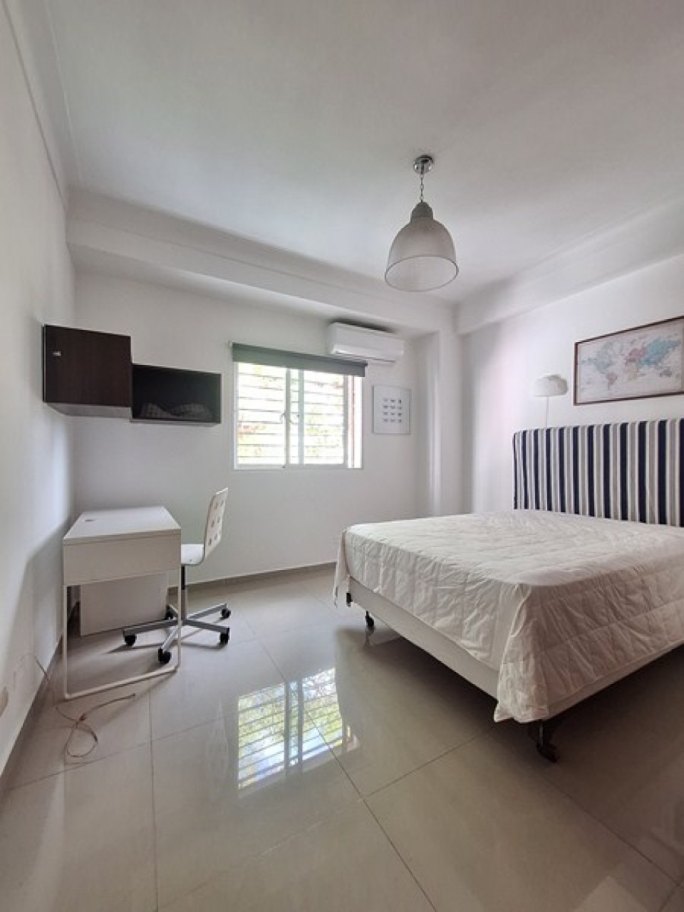 Second bedroom with desk and world map art